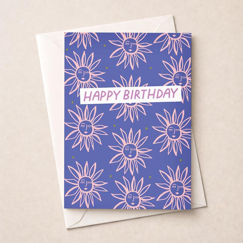 A cheerful birthday card with pink and green sunflowers on a blue background. "Happy Birthday" message adds a heartfelt touch. Ideal for nature lovers.