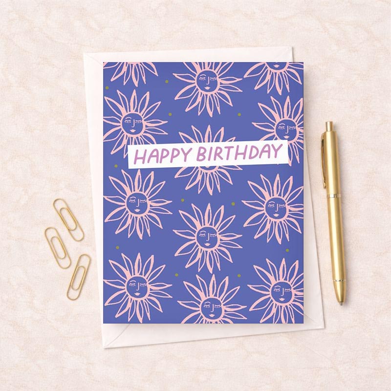 A cheerful birthday card with pink and green sunflowers on a blue background. "Happy Birthday" message adds a heartfelt touch. Ideal for nature lovers.