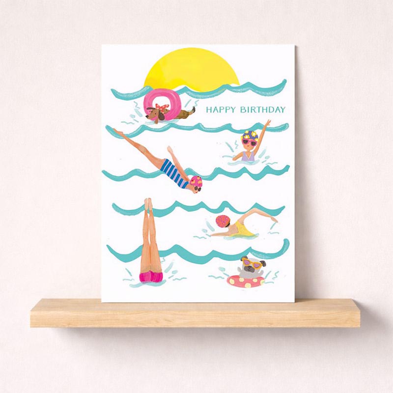 Vibrant beach scene with people swimming in ocean. Perfect for birthdays or to brighten someone's day. Share the sunshine!