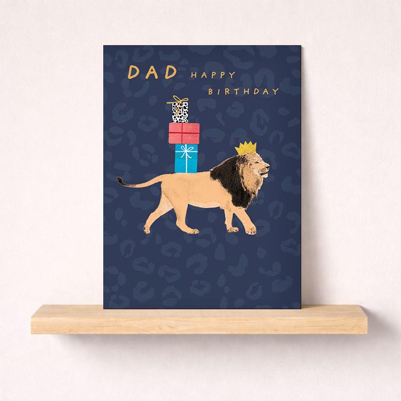 Colourful greetings card with regal lion wearing crown, carrying presents. Playful design to bring joy to recipient's day.