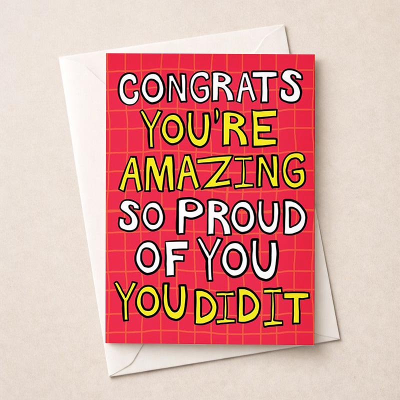 Pink greetings card with message: "CONGRATS YOU'RE AMAZING SO PROUD OF YOU YOU DID IT" - perfect for celebrating achievements.