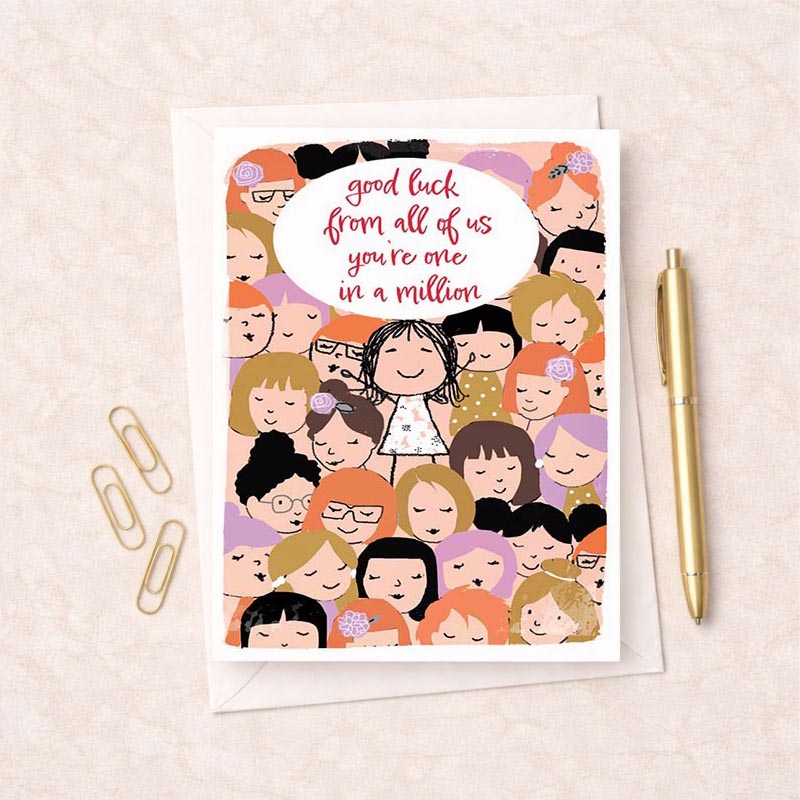A4 greetings card with girl surrounded by well-wishers, speech bubble says "good luck from all of us in a million.