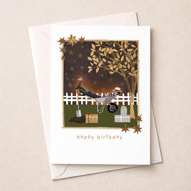 A charming greetings card with a man in a wheelbarrow, shovel, and bird. Rustic and whimsical design to bring cheer to friends and family.