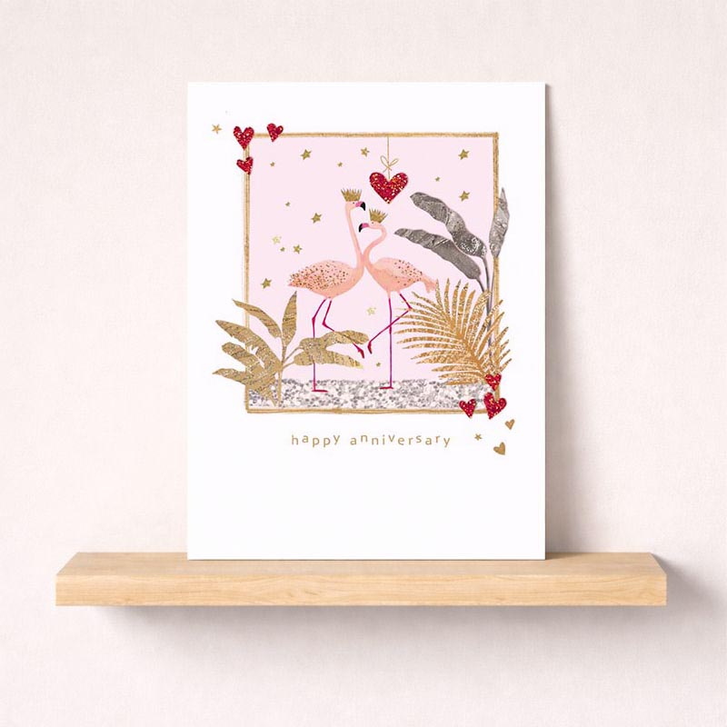 Pink flamingo greetings card with gold frame, heart, and two flamingos with crown. Perfect for celebrating love and special occasions.