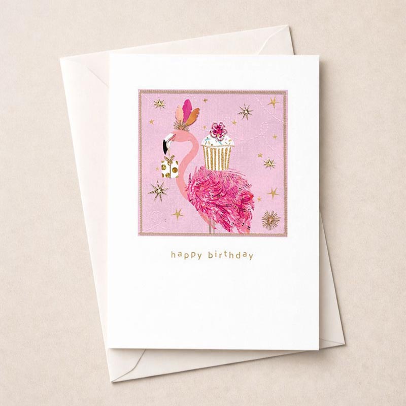 Adorable pink flamingo greetings card with cupcake under starlit sky. Perfect for birthdays and celebrations. Spread joy with this cute design.