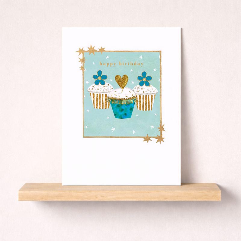 Charming cupcakes card with heart to celebrate special occasions. Gold and blue design adds elegance. Perfect for birthdays, anniversaries, or just to brighten someone's day.