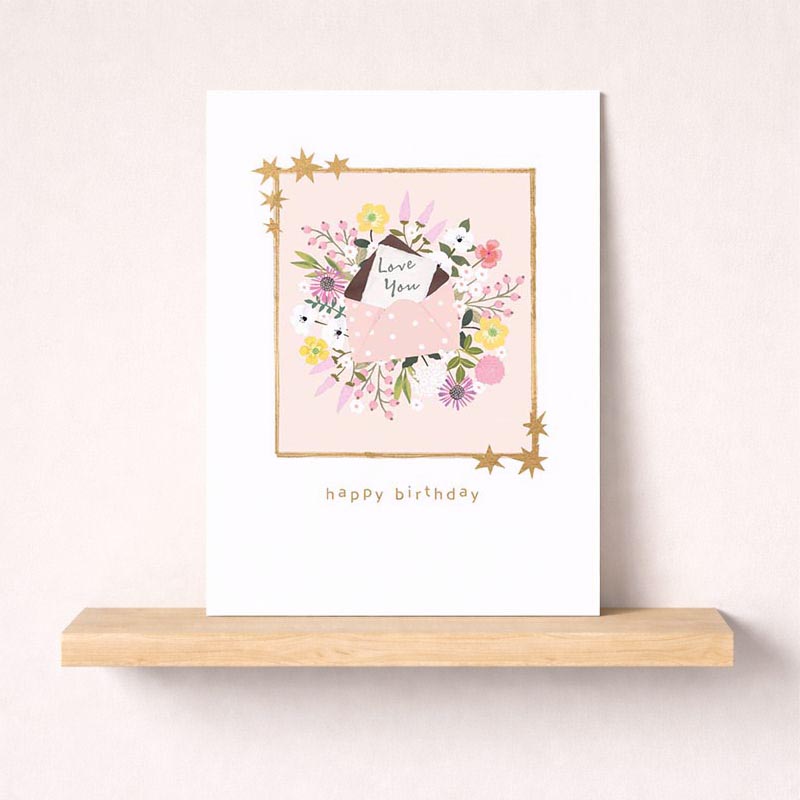Pink birthday card with floral design, gold accents, and cute dog illustration. Perfect for any special occasion.
