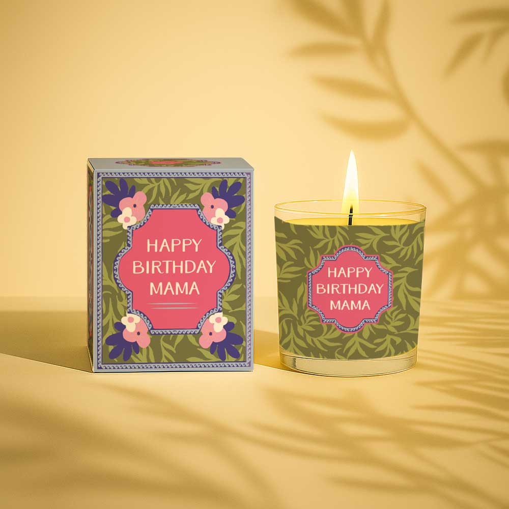 Lit yellow candle with happy birthday mama label next to matching decorative box