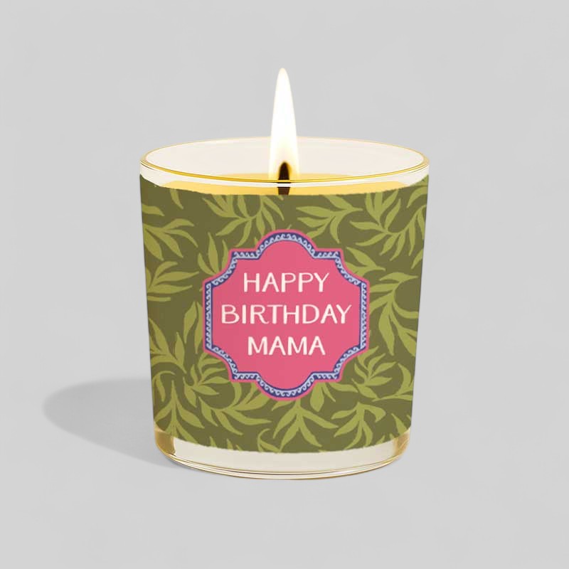 Lit yellow candle with happy birthday mama label next to matching decorative box