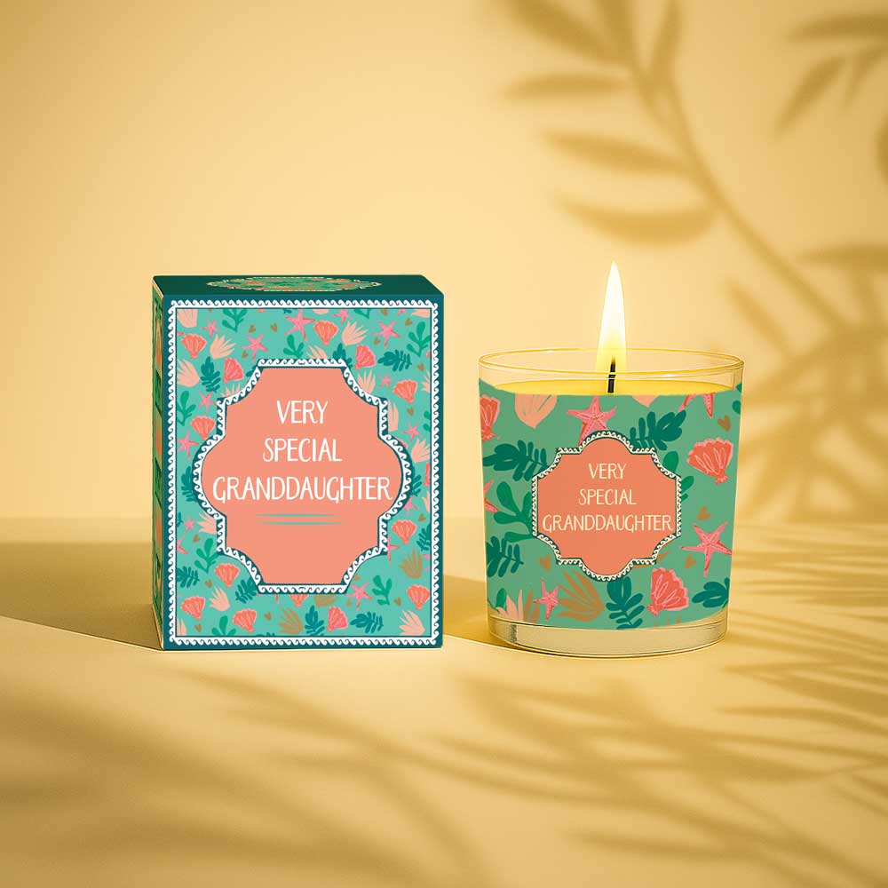 Lit yellow candle and matching box with floral design and text Very Special Granddaughter