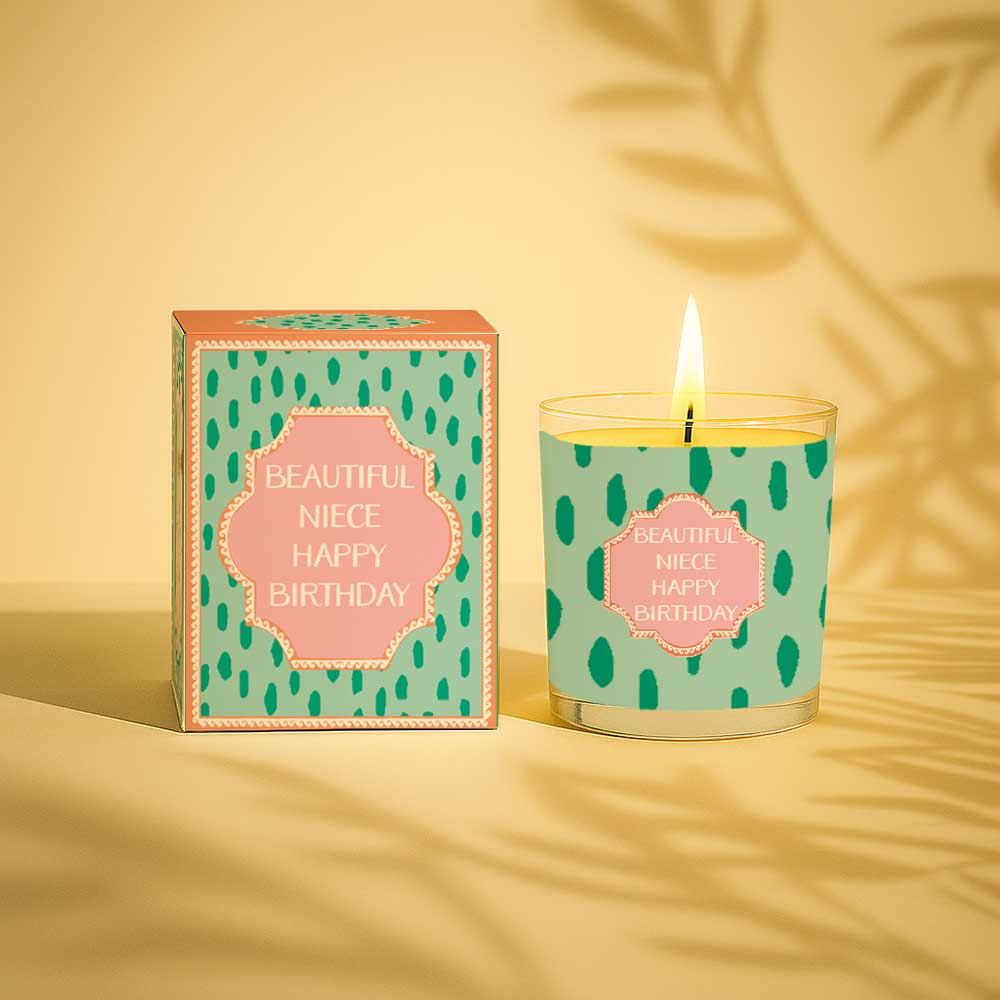 Lit yellow candle and matching box with beautiful niece happy birthday text