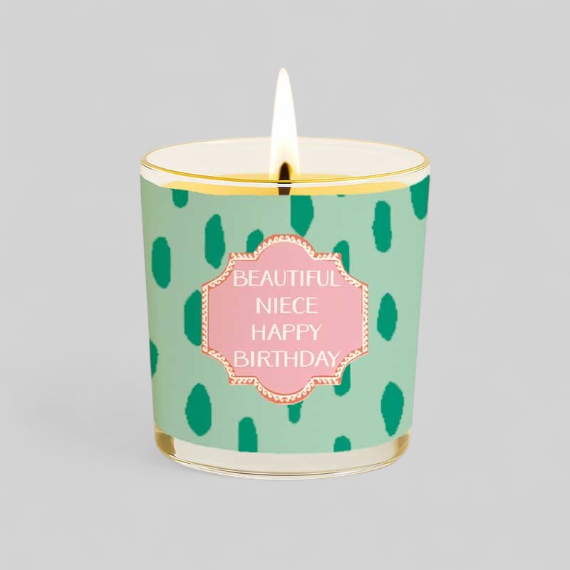 Lit yellow candle and matching box with beautiful niece happy birthday text