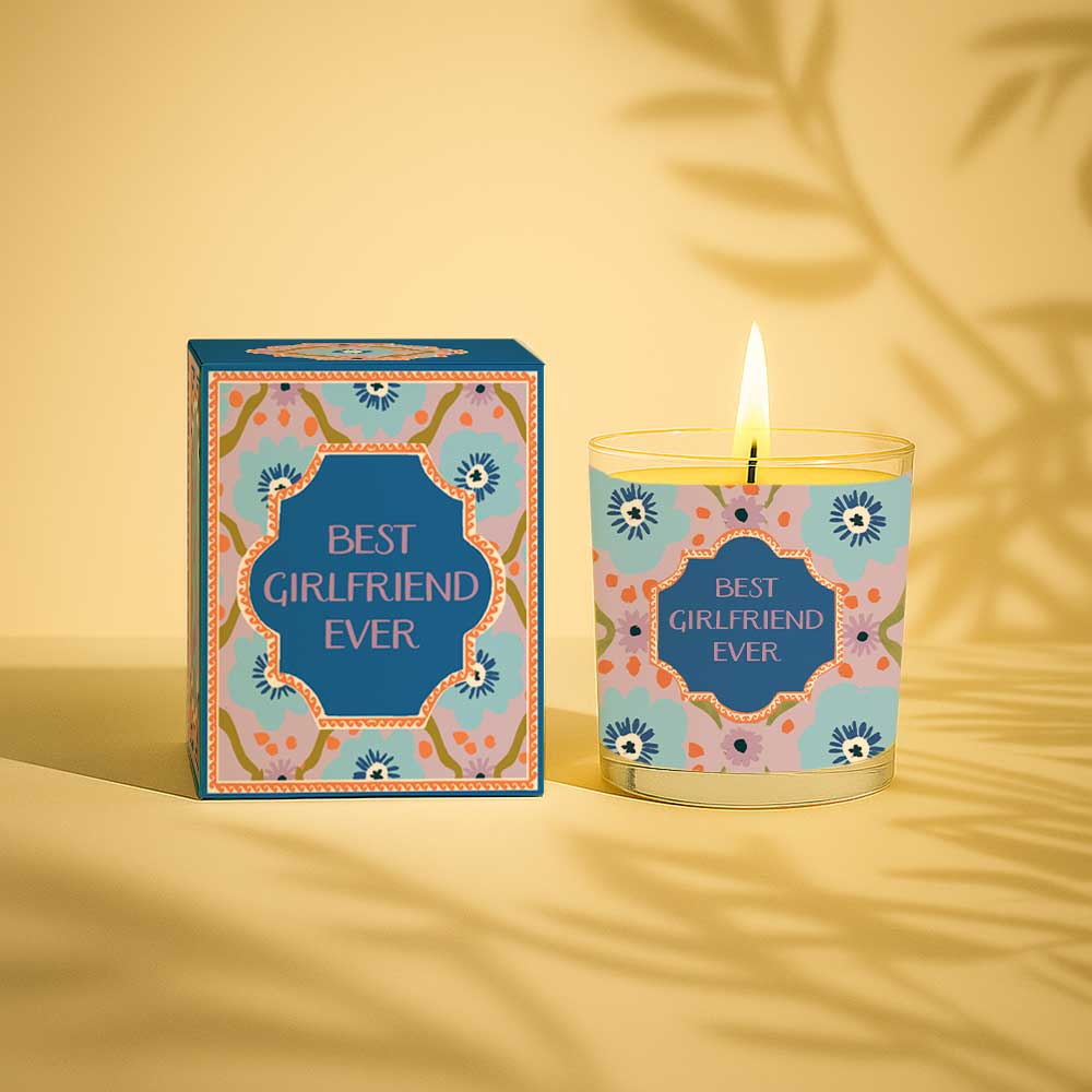 Lit yellow candle in glass with best girlfriend ever label and matching box