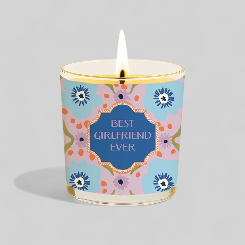 Lit yellow candle in glass with best girlfriend ever label and matching box