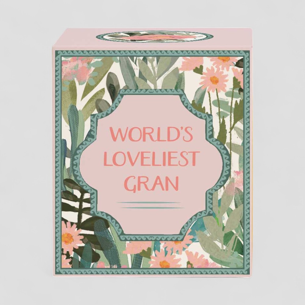 Lit yellow candle and box with floral design and text Worlds Loveliest Gran