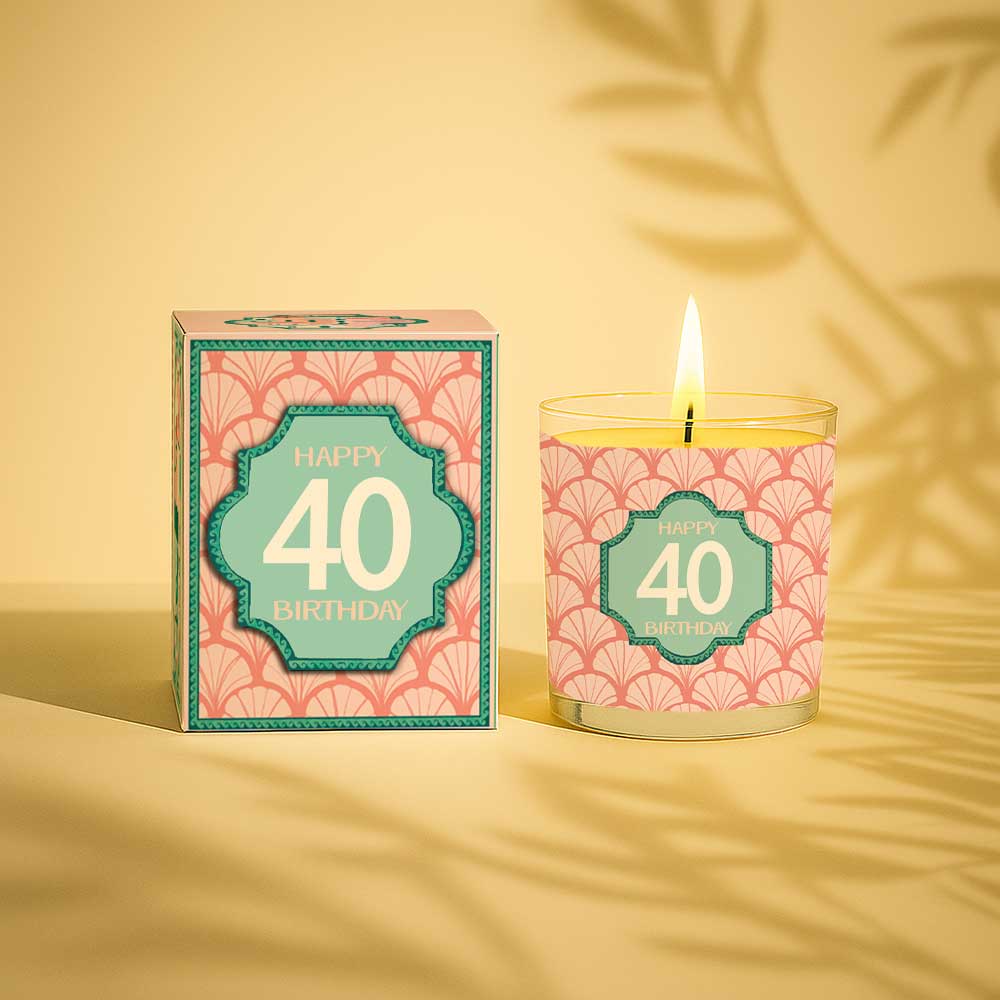 Burning yellow candle with Happy 40 birthday label and matching gift box