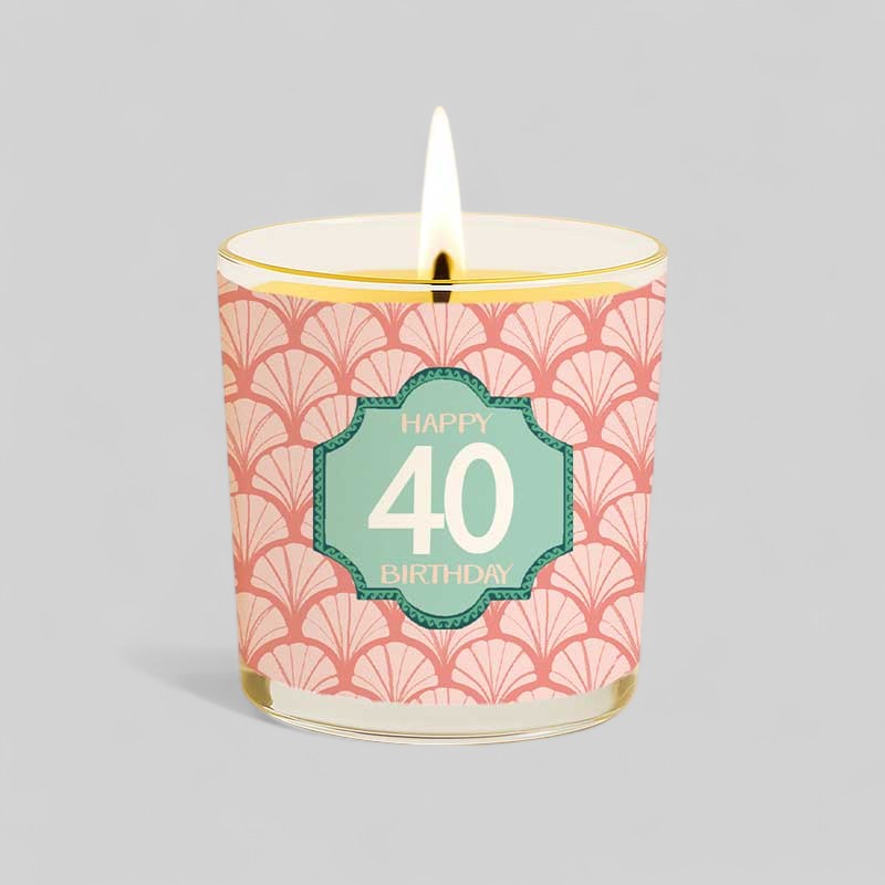 Burning yellow candle with Happy 40 birthday label and matching gift box
