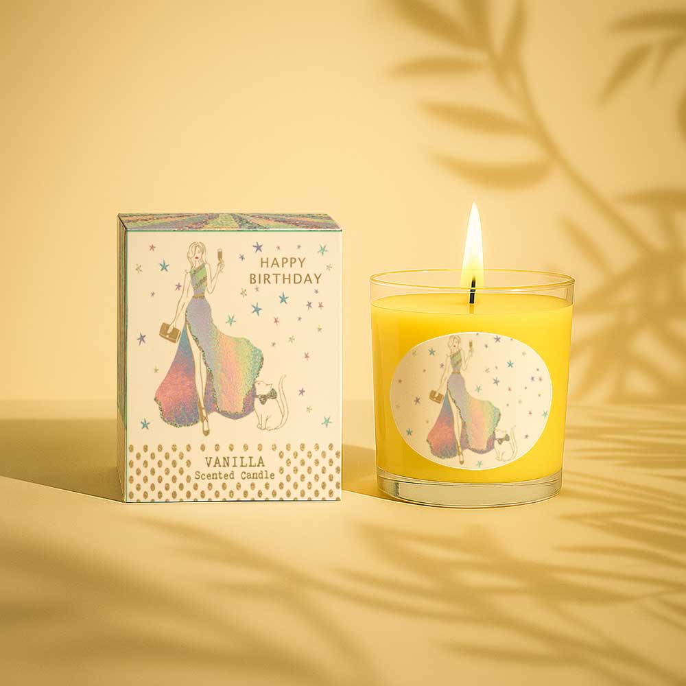 Lit vanilla scented candle with happy birthday packaging and colourful design