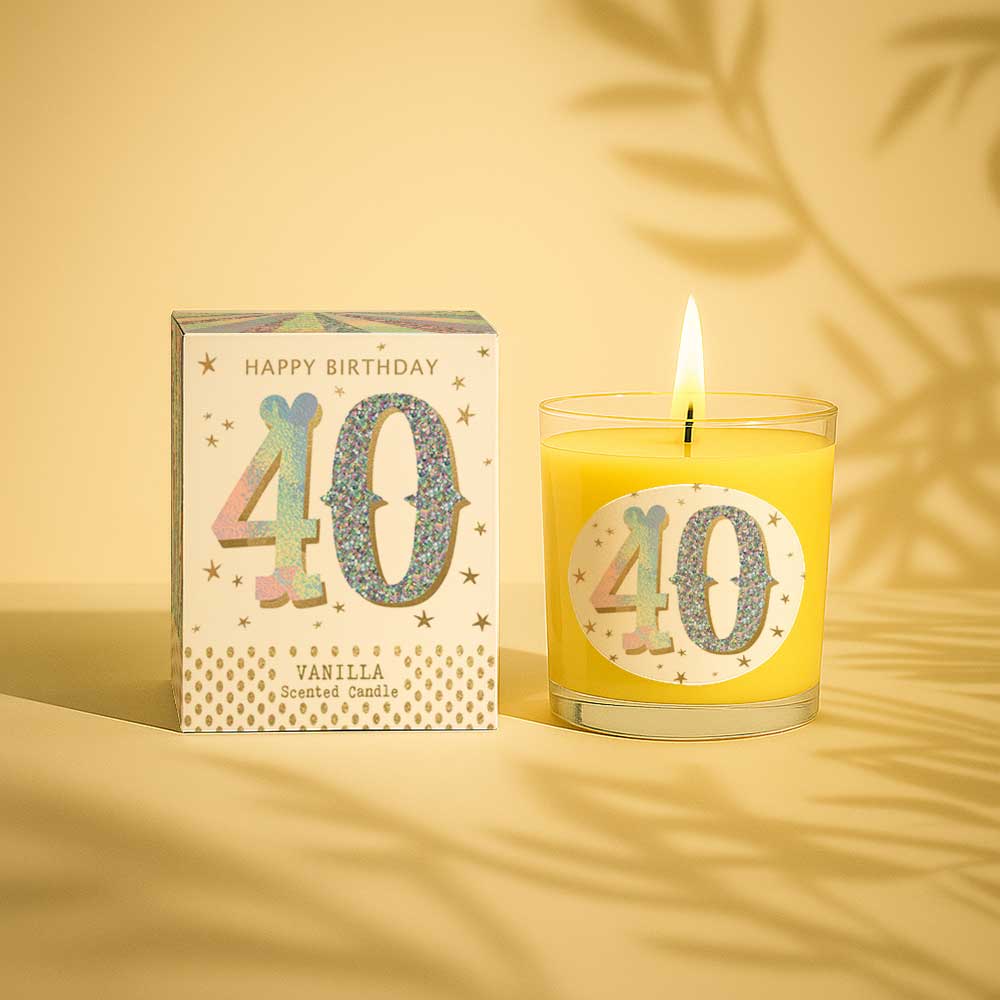 Vanilla scented birthday candle with glittery 40 design and box on a grey background