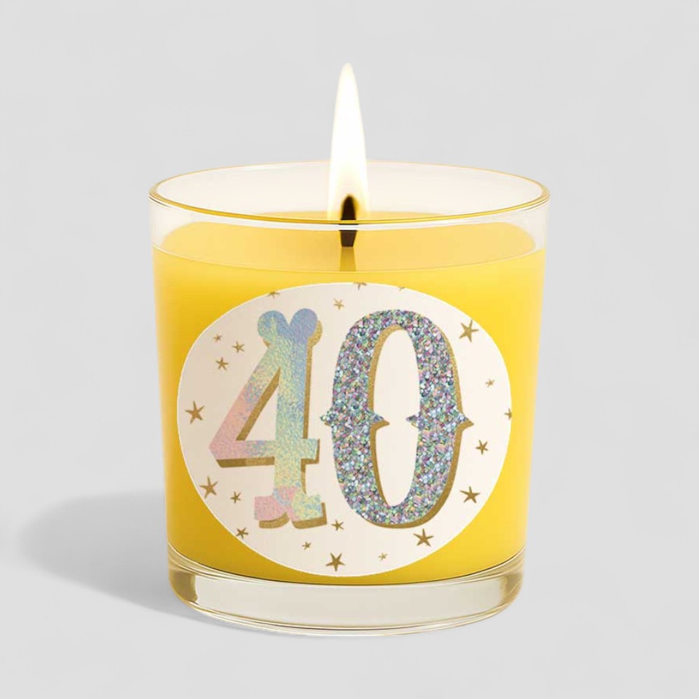Vanilla scented birthday candle with glittery 40 design and box on a grey background
