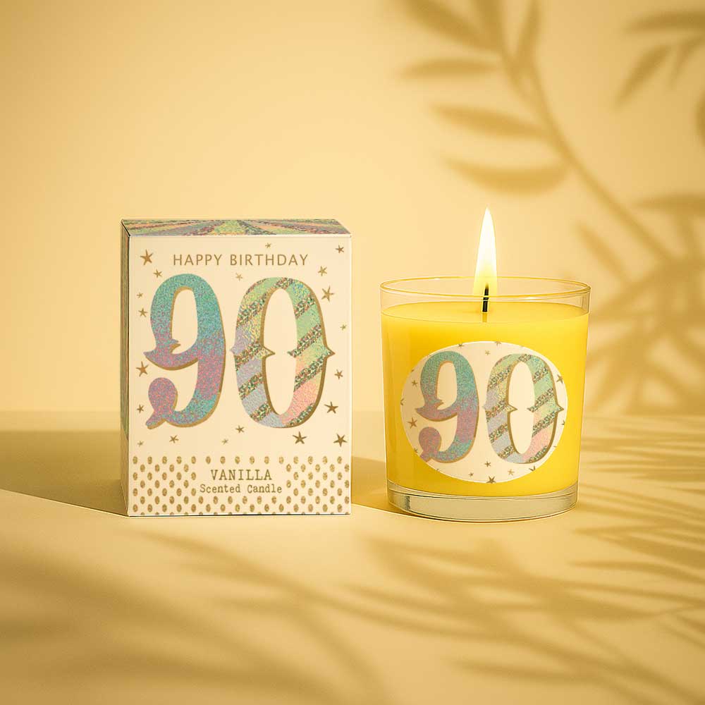 Vanilla scented birthday candle with 90 on label and box lit against white background