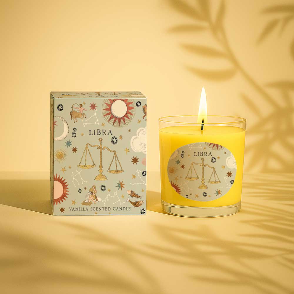 Lit vanilla scented Libra zodiac candle with decorative box and glass holder