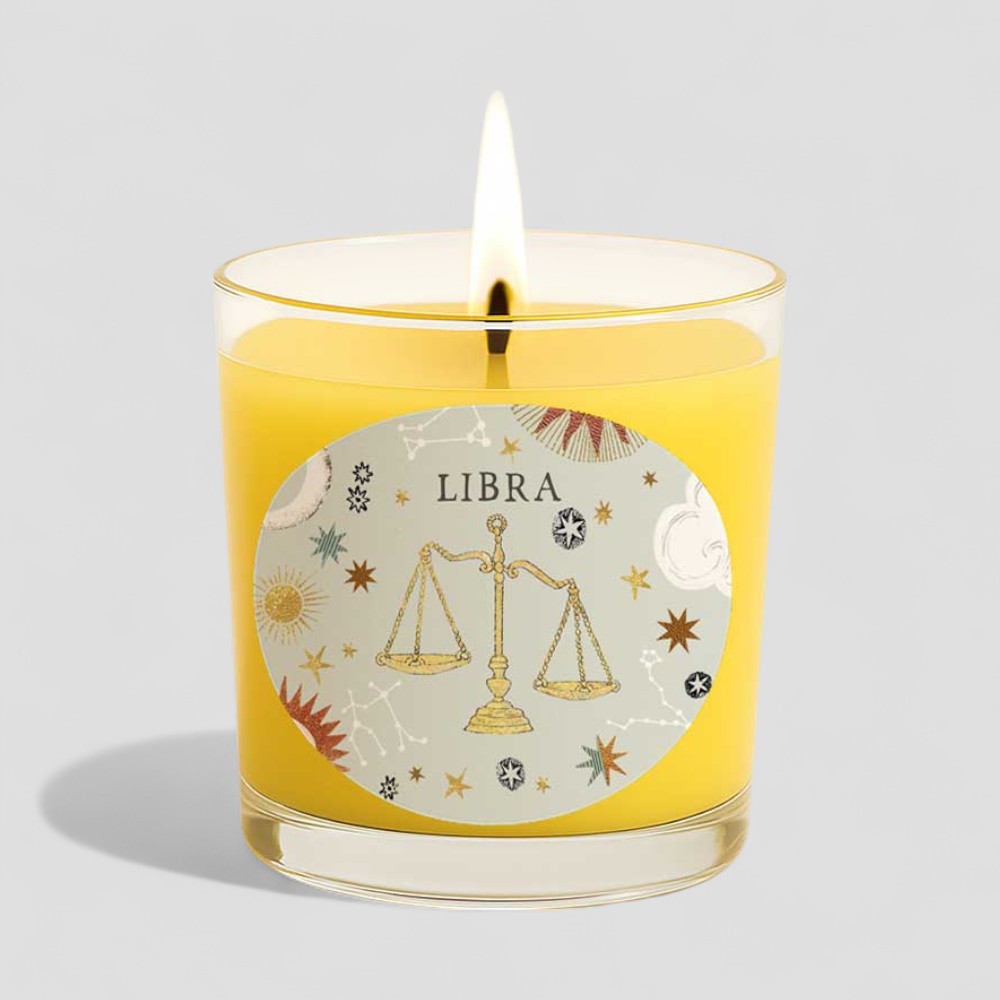 Lit vanilla scented Libra zodiac candle with decorative box and glass holder
