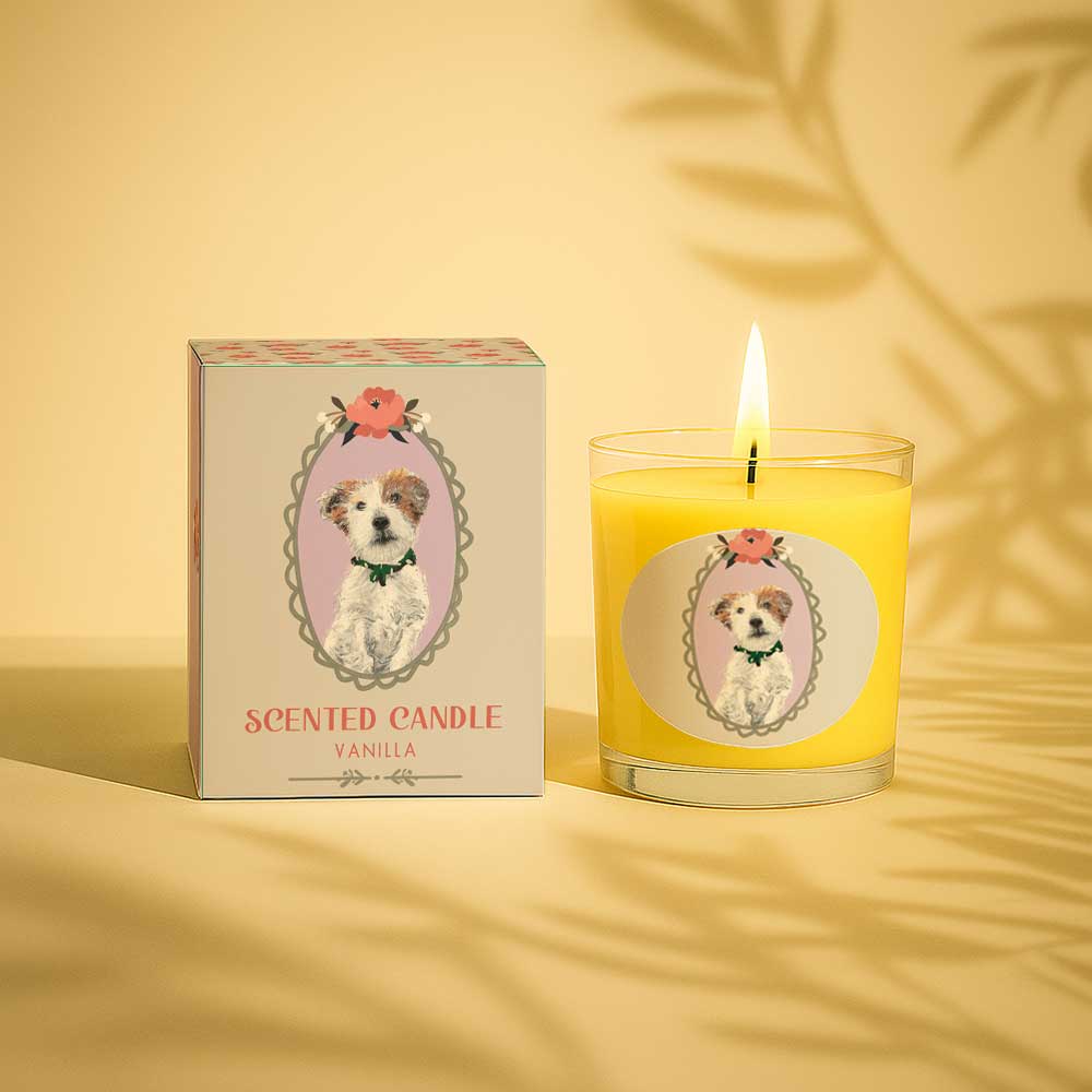 Vanilla scented candle with dog illustration on box and glass burning on white background