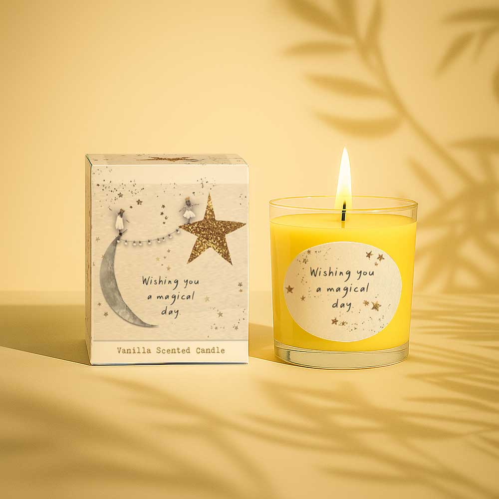 Lit vanilla scented candle with wishing you a magical day message and decorative box.