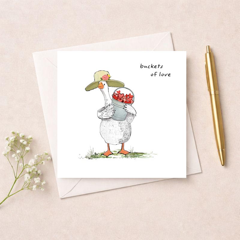 A cute duck with flowers in a bucket on a greetings card, perfect for spreading love and cheer. Ideal for any occasion to bring a smile to someone's face.
