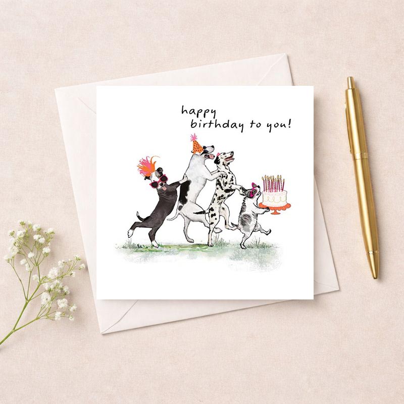 Adorable greetings card with playful dogs and birthday cake, perfect for spreading cheer and celebrating special occasions.