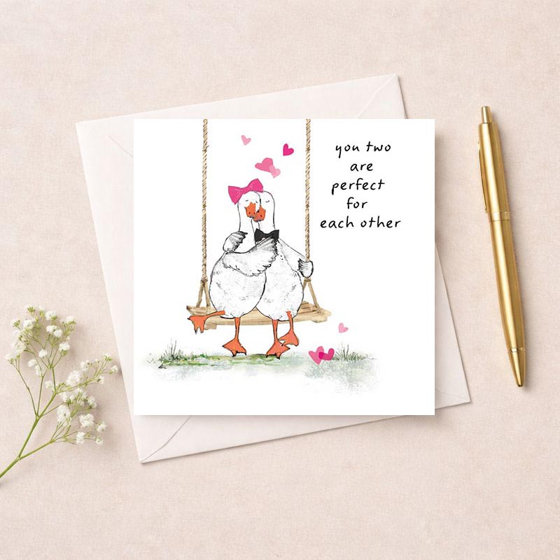 Sweet and charming greetings card with ducks on swing surrounded by hearts, perfect for expressing love and affection.