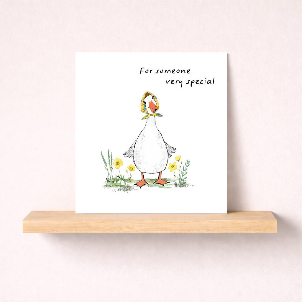 Cheerful duck holding flower on greetings card. Perfect for spreading joy and love. Ideal for sending warm wishes to someone special.