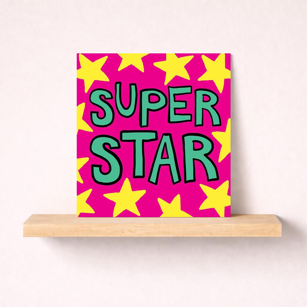 Bright pink greetings card with "SUPER STAR" message surrounded by yellow stars, perfect for celebrating someone special.