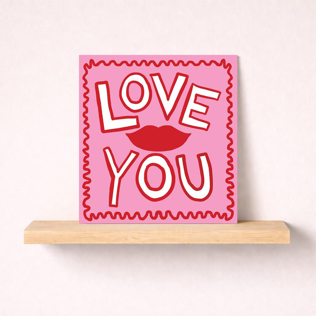 Romantic pink greetings card with "Love You" sign, perfect for expressing love on Valentine's Day or any special occasion.