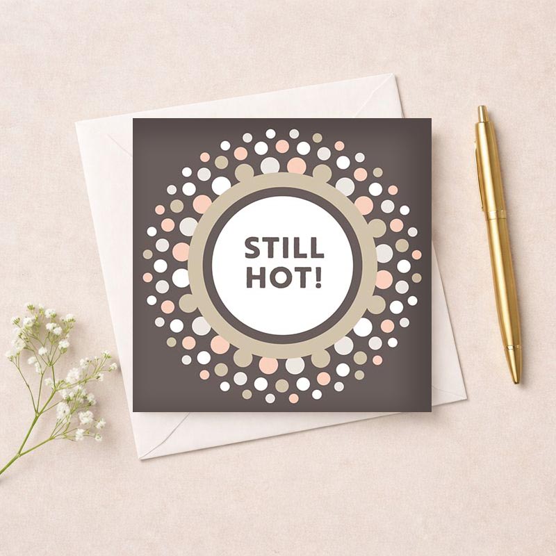 Cheerful greetings card with "STILL HOT!" message, perfect for those who enjoy humor and playfulness. Eye-catching design with dots and bold text.