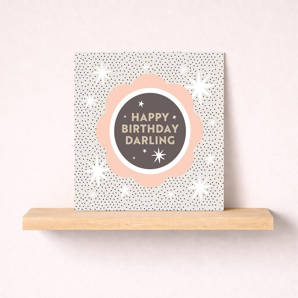 Birthday card with "HAPPY BIRTHDAY DARLING" in elegant text, star, and circle design. Perfect for expressing love and affection.
