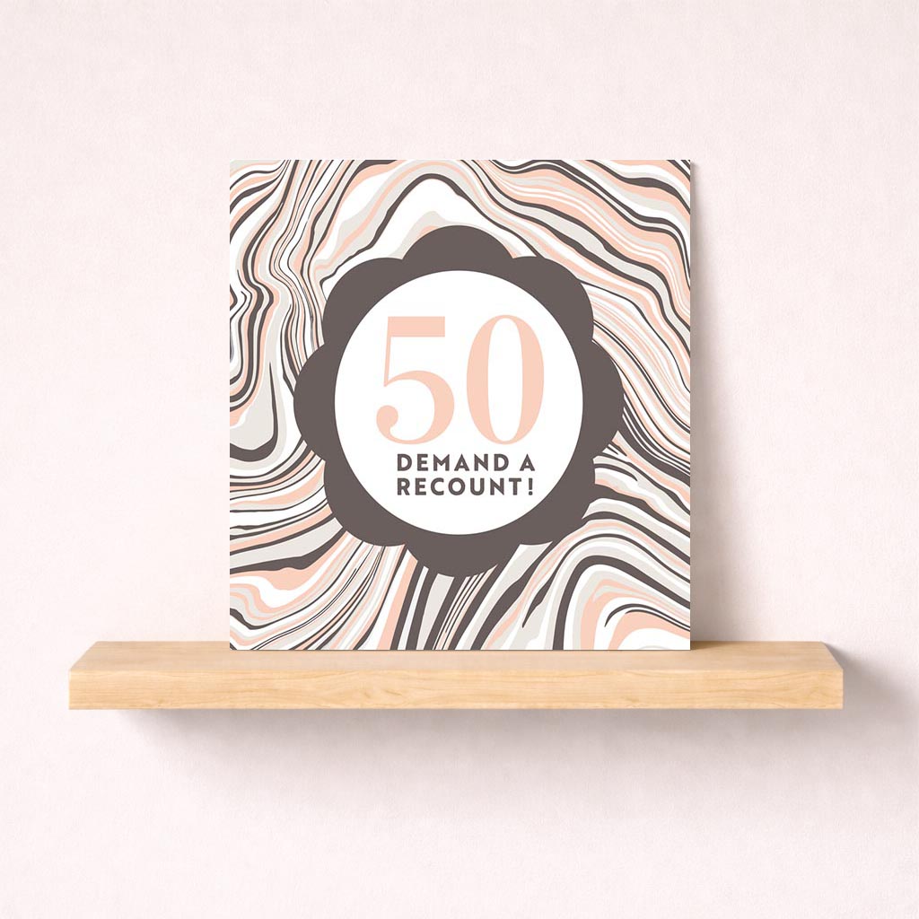 A bold greetings card reads "50 DEMAND A RECOUNT!" on a marble background. Perfect for a light-hearted message.