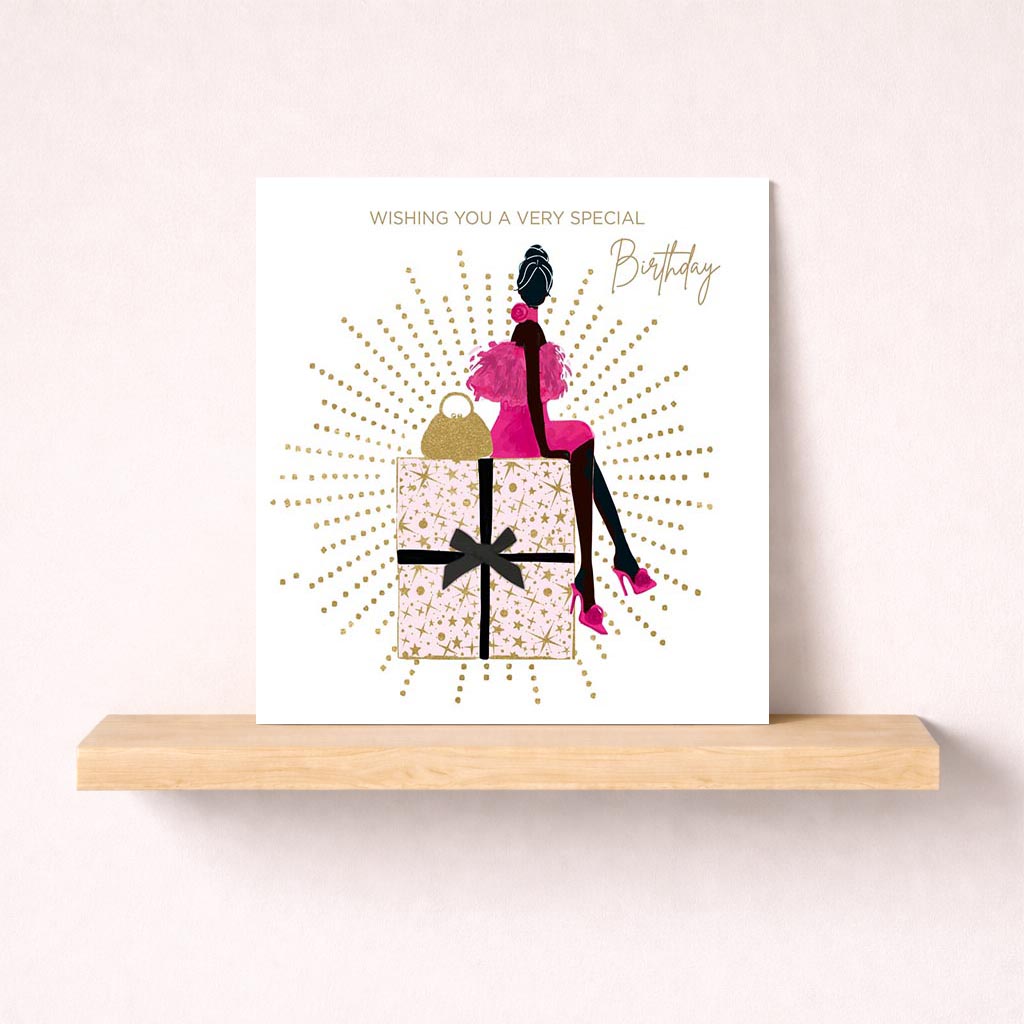 Stylish greetings card with woman on present, perfect for special occasions. Elegant and heartfelt design. Ideal for showing you care.