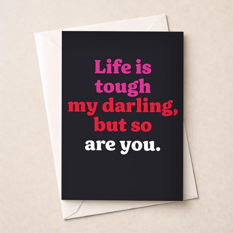 Charming black greetings card with red and pink text: "Life is tough, my darlings, but so are you." Encouraging and empowering for anyone who needs a pick-me-up. Great for birthdays, graduations, or just because moments.