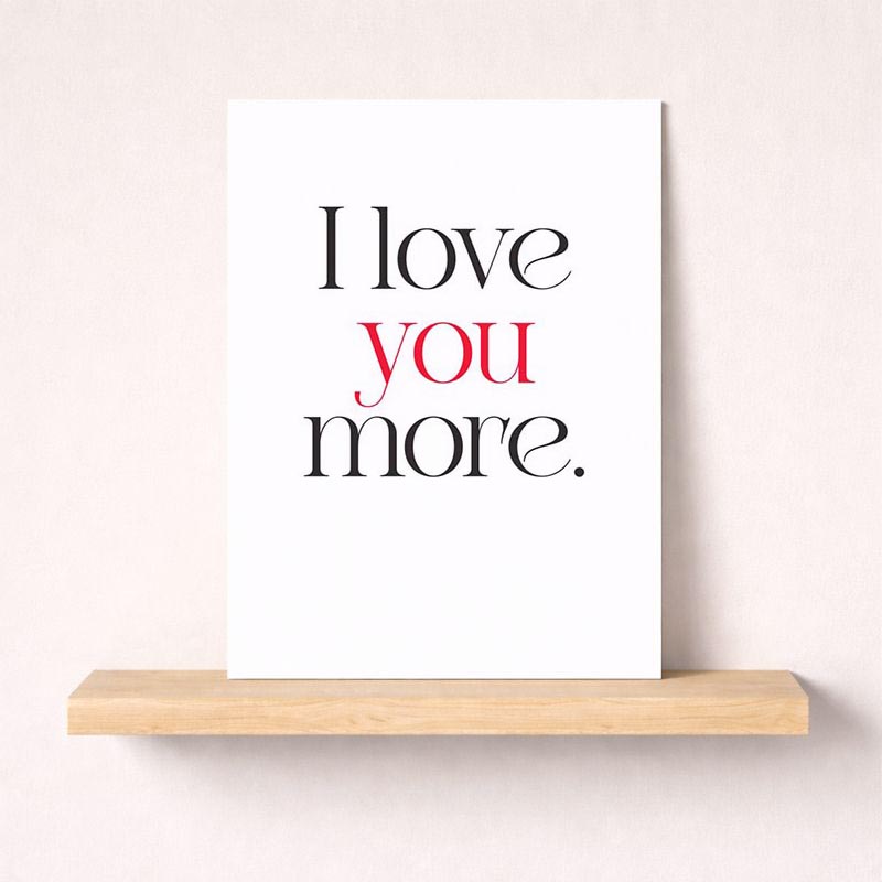 Modern black and white card with "I love you more" in bold red and black. Ideal for expressing love to someone special.