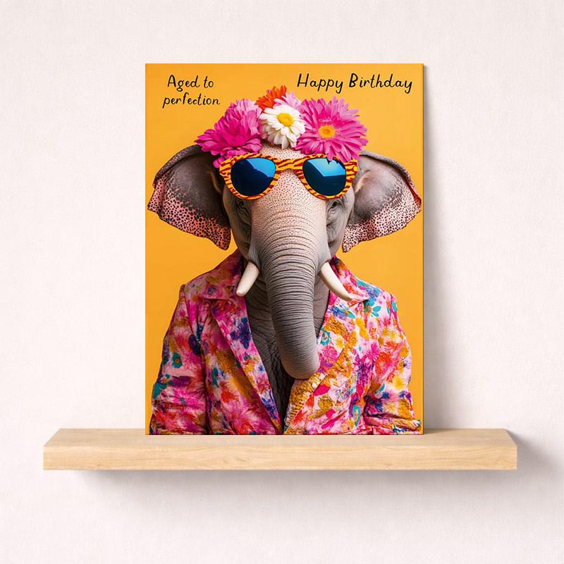 Adorable greetings card with cool elephant in sunglasses and floral hat, perfect for spreading joy on special occasions.