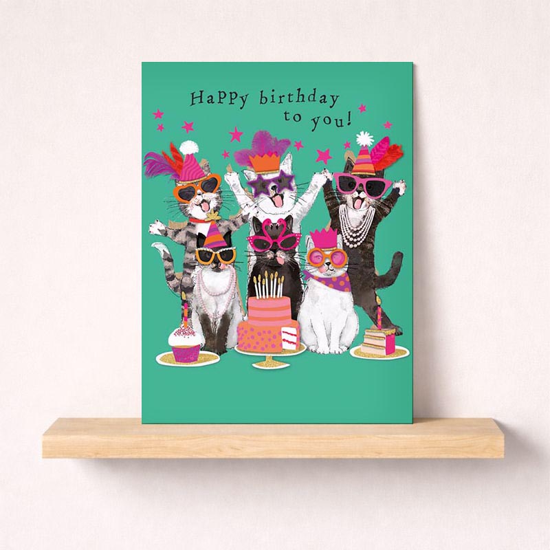 A fun greetings card with cool cats in party hats and sunglasses, perfect for birthdays and celebrations.