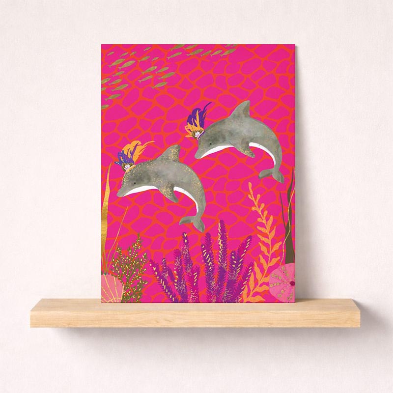 Cheerful dolphin-themed greetings card with hats and crowns, perfect for spreading joy and positivity. Suitable for all ages and occasions.