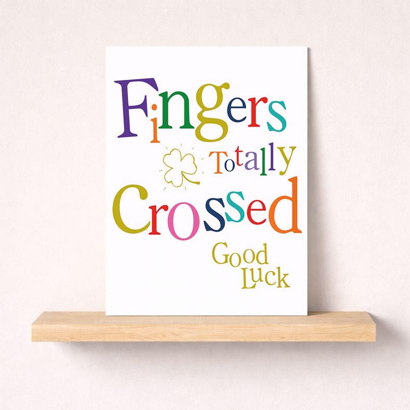 Colorful greetings card with 'fingers totally crossed' in vibrant colors and shamrock detail. Perfect for sending positive thoughts to loved ones.