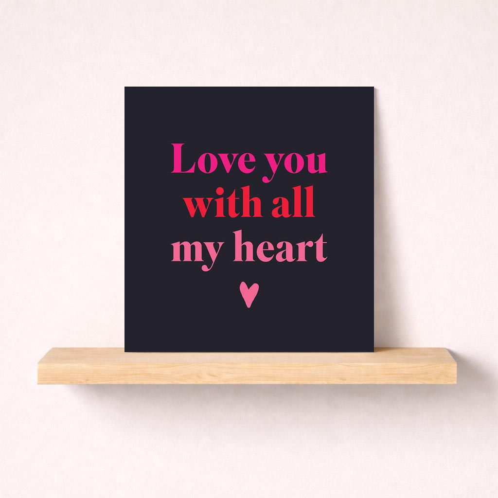 Heartfelt greetings card with pink heart on black background and "Love you with all my heart" message. Express deep love and appreciation.