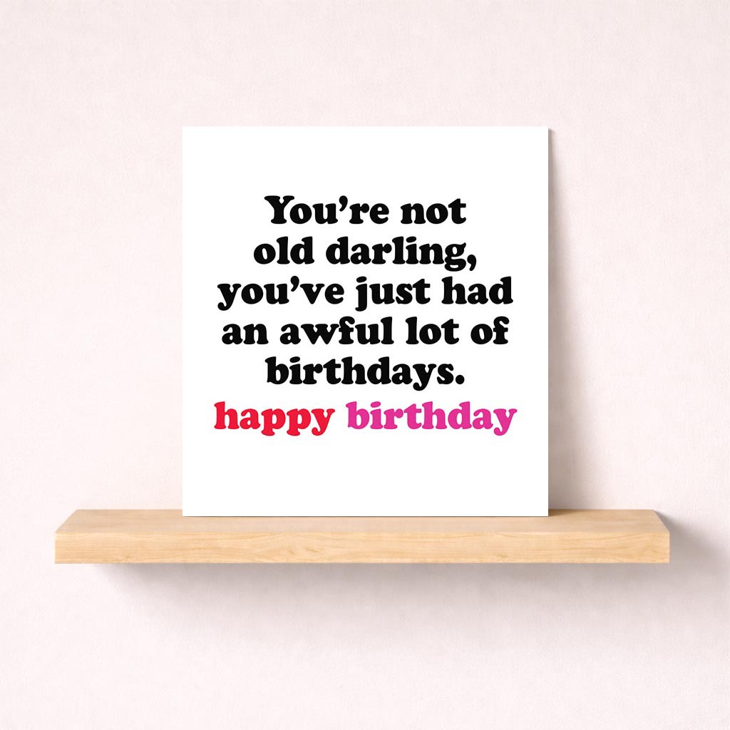 Birthday card with quote: "You're not old darling, you've just had a lot of birthdays." Elegant black and white design.