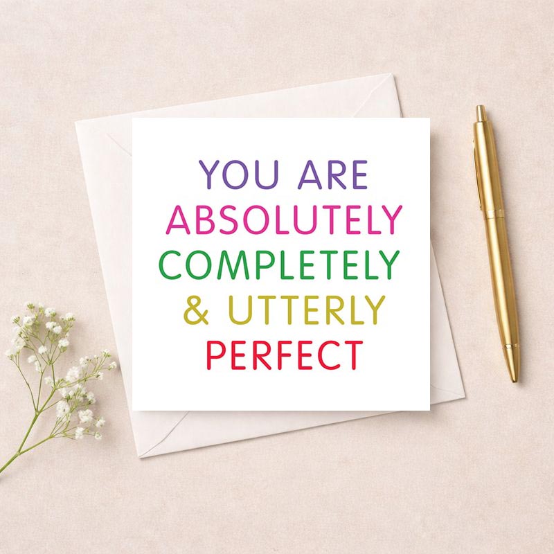 Vibrant greetings card with bold text: "YOU ARE ABSOLUTELY COMPLETELY &amp; UTTERLY PERFECT" - a heartwarming message of worth and uniqueness, ideal for spreading joy and positivity.