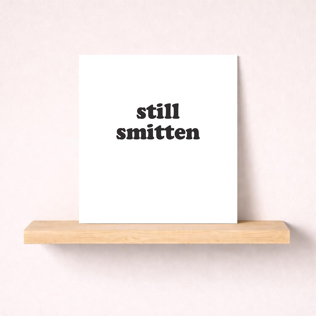 Still smitten" black and white greetings card for enduring love. Ideal for birthdays, anniversaries, or spontaneous gestures.