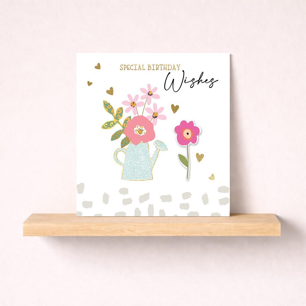 Charming greetings card with flowers and watering can, perfect for birthdays or to spread cheer to a loved one.